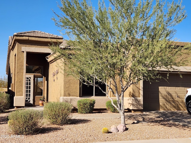 view of front of property featuring stucco siding and an attached garage