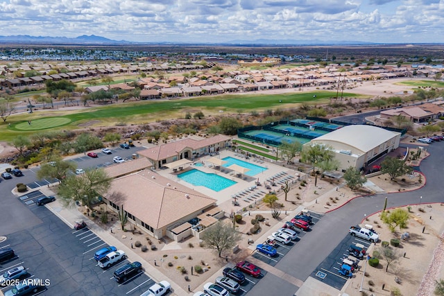 drone / aerial view with a mountain view, a residential view, and golf course view