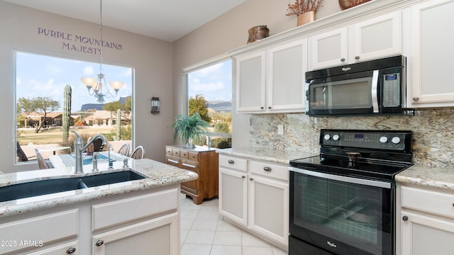 kitchen featuring a sink, decorative backsplash, black microwave, and range with electric cooktop