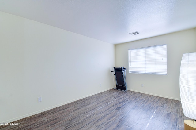 empty room with wood-type flooring