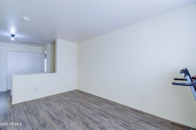 spare room with dark hardwood / wood-style flooring