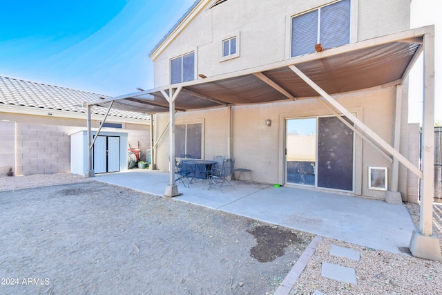 10856 E Arcadia Ave, Mesa, AZ 85208 - rear view of house with a storage unit, a patio, and stucco siding