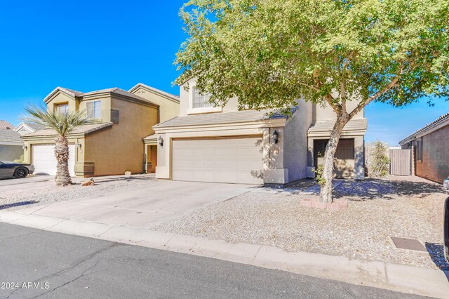 10856 E Arcadia Ave, Mesa, AZ 85208 - view of front facade featuring an attached garage, stucco siding, and driveway