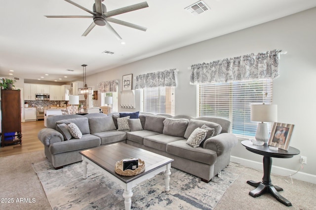 living room with baseboards, visible vents, ceiling fan, and recessed lighting