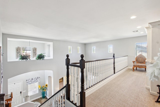 hallway featuring recessed lighting, carpet flooring, an upstairs landing, visible vents, and baseboards