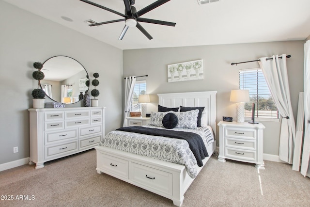 bedroom featuring lofted ceiling, baseboards, multiple windows, and visible vents