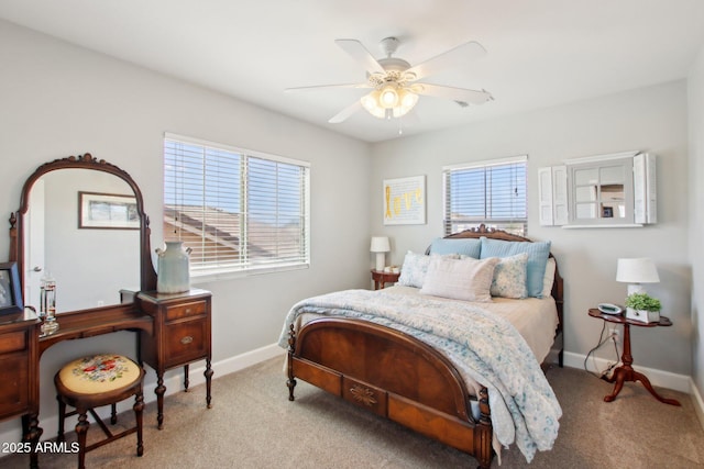 bedroom with a ceiling fan, carpet flooring, and baseboards