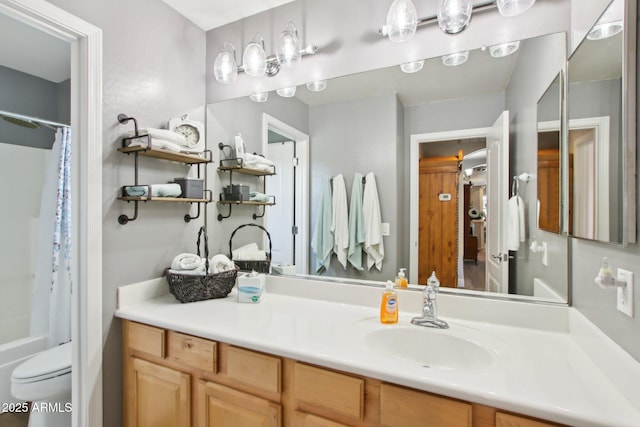 bathroom featuring shower / bath combo, vanity, and toilet