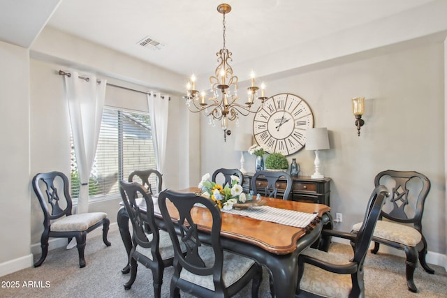 dining room featuring baseboards, carpet floors, visible vents, and a notable chandelier