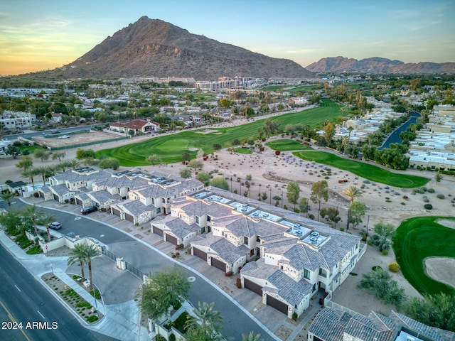 aerial view at dusk featuring a mountain view