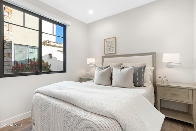 bedroom with dark wood-type flooring