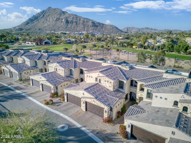 birds eye view of property with a mountain view