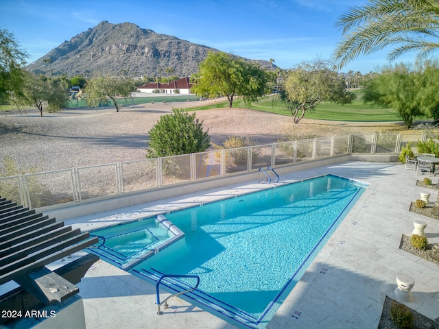 view of pool featuring a mountain view and a patio