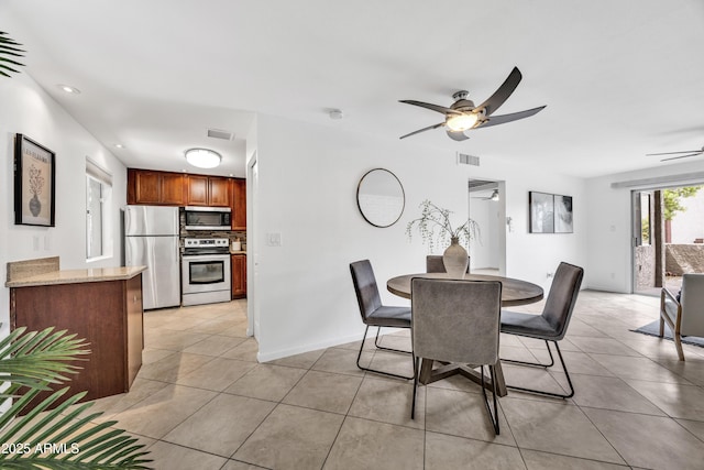 dining room with ceiling fan, light tile patterned flooring, recessed lighting, and baseboards