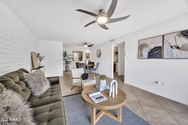 living area featuring a ceiling fan and tile patterned flooring