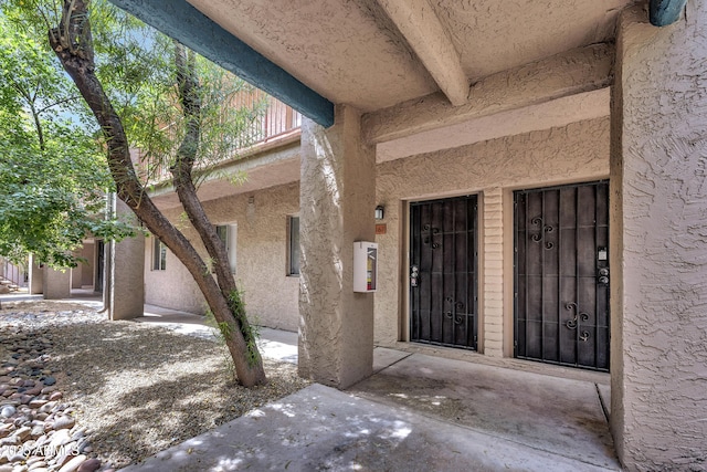 doorway to property with stucco siding
