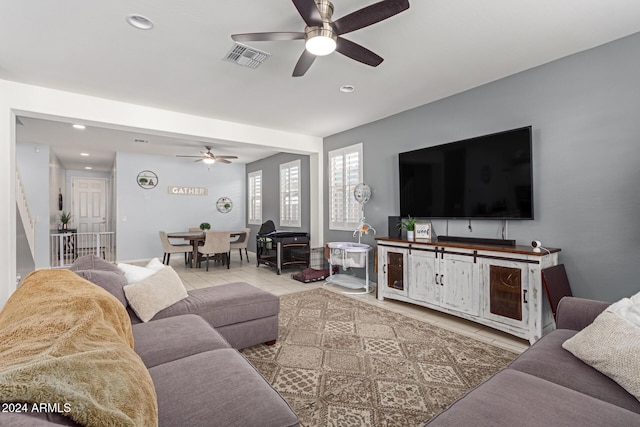 tiled living room featuring ceiling fan