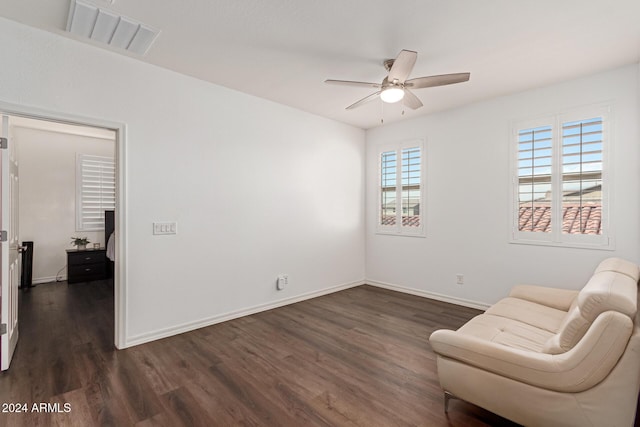 sitting room featuring dark hardwood / wood-style flooring and ceiling fan