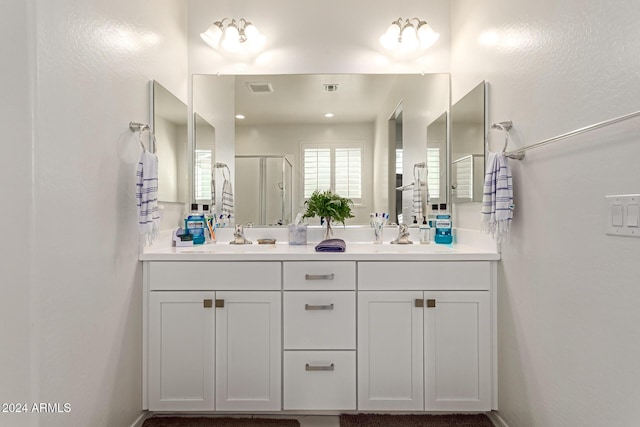 bathroom featuring vanity and a shower with shower door