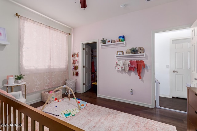 bedroom with ceiling fan and dark wood-type flooring