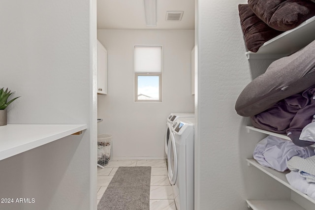 clothes washing area featuring independent washer and dryer and light tile patterned floors