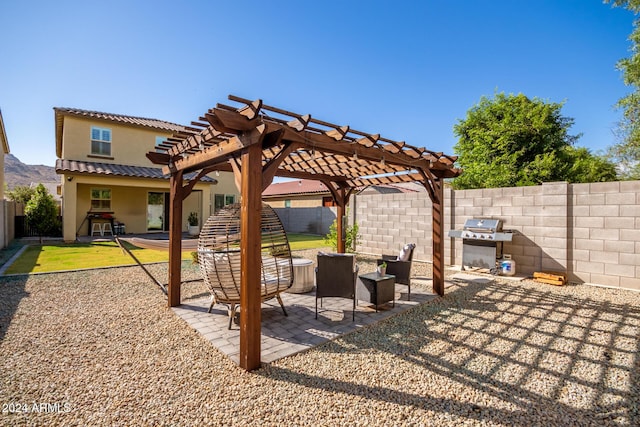 view of patio with a pergola and a grill