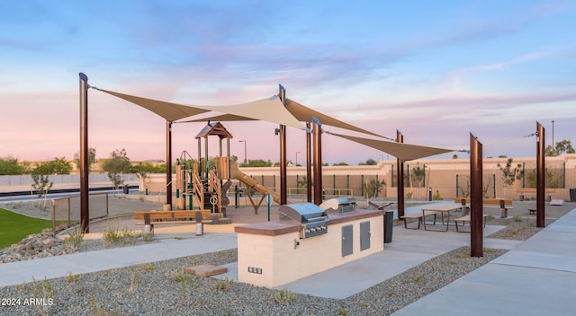 playground at dusk with an outdoor kitchen