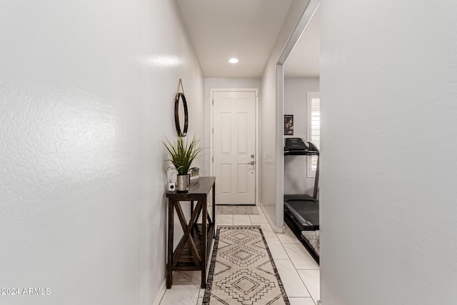 corridor featuring light tile patterned floors