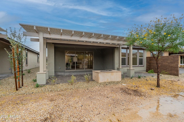 back of property featuring a patio and a pergola