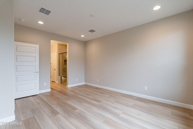 spare room featuring light hardwood / wood-style floors