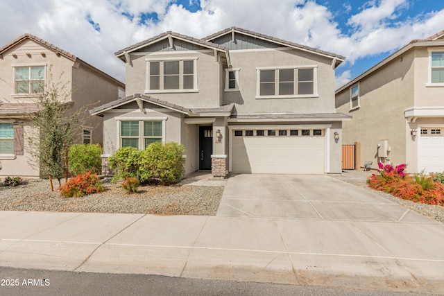 craftsman inspired home with a garage, concrete driveway, a tiled roof, and stucco siding