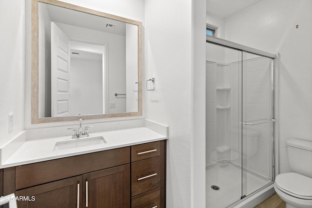 full bathroom with visible vents, a stall shower, vanity, and toilet