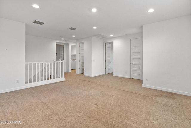 carpeted empty room featuring recessed lighting, visible vents, and baseboards