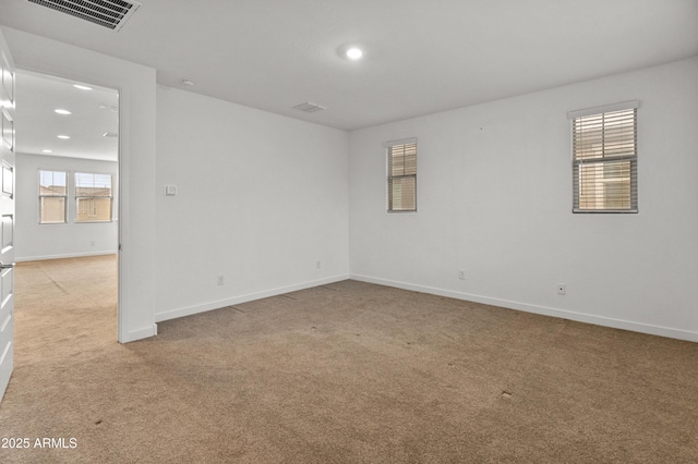 unfurnished room featuring recessed lighting, visible vents, light carpet, and baseboards