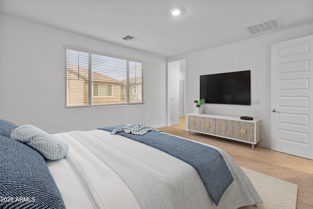 carpeted bedroom featuring baseboards and visible vents