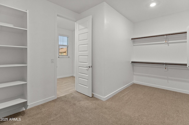 walk in closet featuring carpet