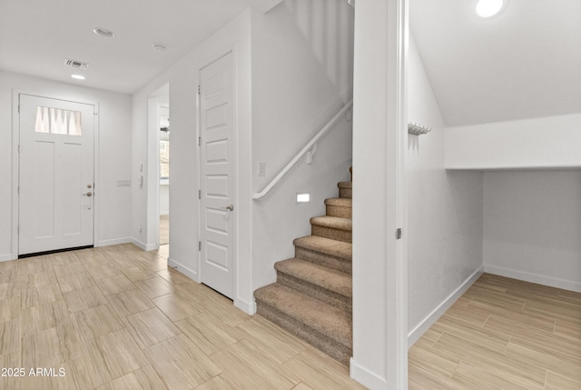 entrance foyer with stairway, wood finish floors, recessed lighting, and baseboards