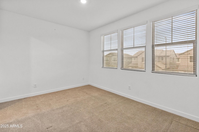 empty room with light carpet and baseboards