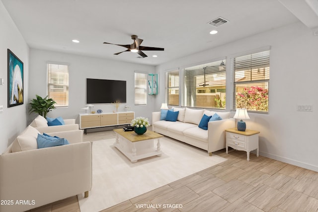 living room with recessed lighting, visible vents, ceiling fan, and baseboards