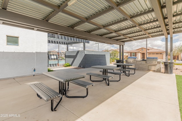 view of property's community featuring a patio, exterior kitchen, and fence