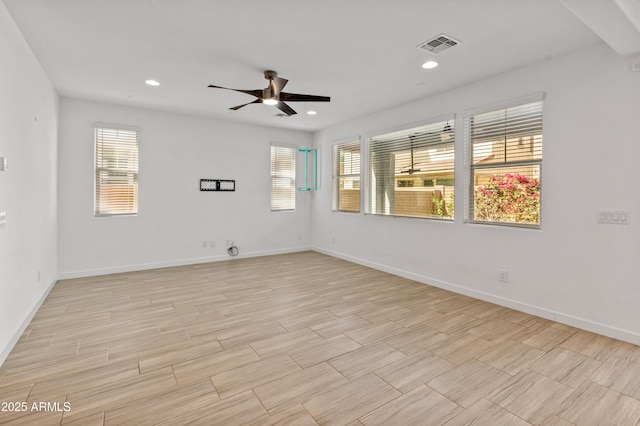 unfurnished room featuring visible vents, plenty of natural light, wood tiled floor, and recessed lighting