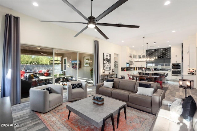 living room with light hardwood / wood-style flooring and ceiling fan