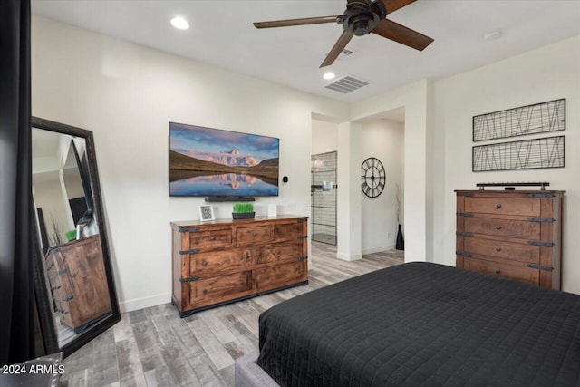 bedroom with ceiling fan and light hardwood / wood-style floors