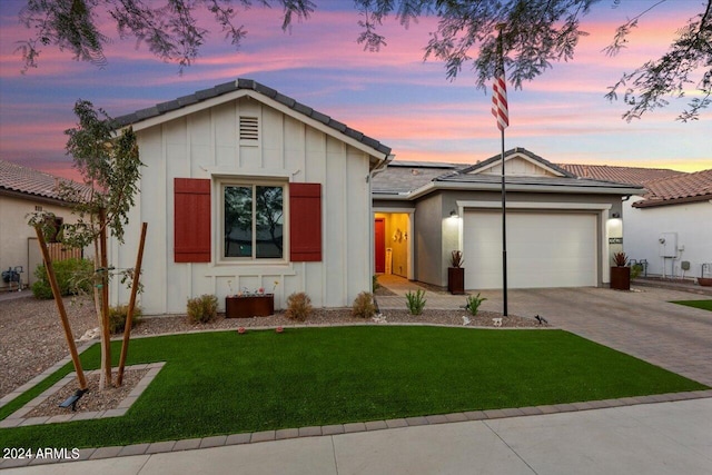 view of front facade with a garage and a lawn