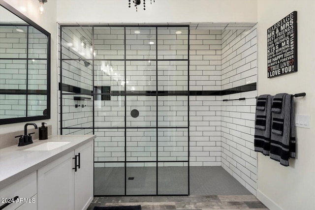 bathroom featuring vanity and tiled shower