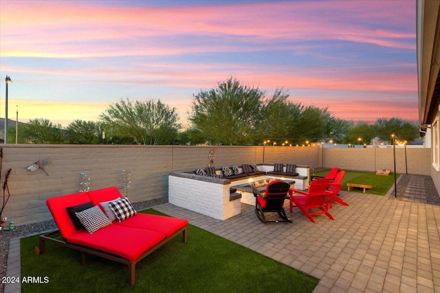 patio terrace at dusk featuring a fire pit