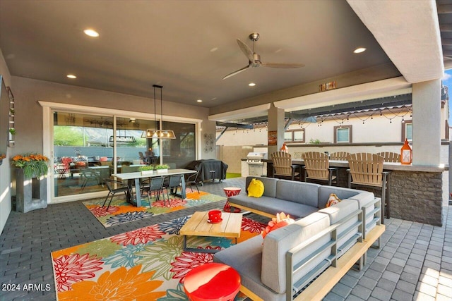 exterior space featuring an outdoor living space, ceiling fan, and grilling area