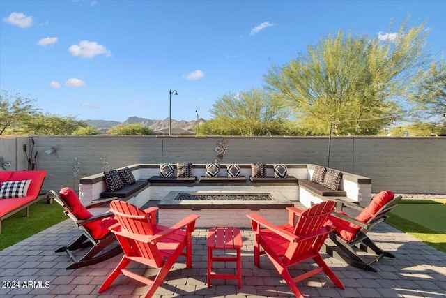 view of patio / terrace featuring a mountain view and an outdoor fire pit