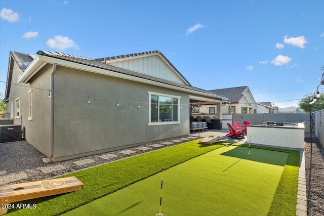 back of property featuring central AC unit and a patio