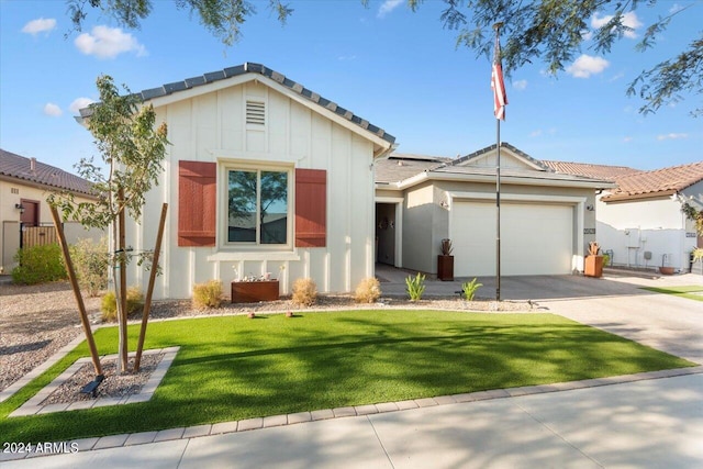 view of front of property with a garage and a front lawn